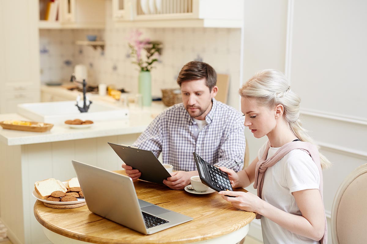 young couple determining budget for kitchen revamp and renovation