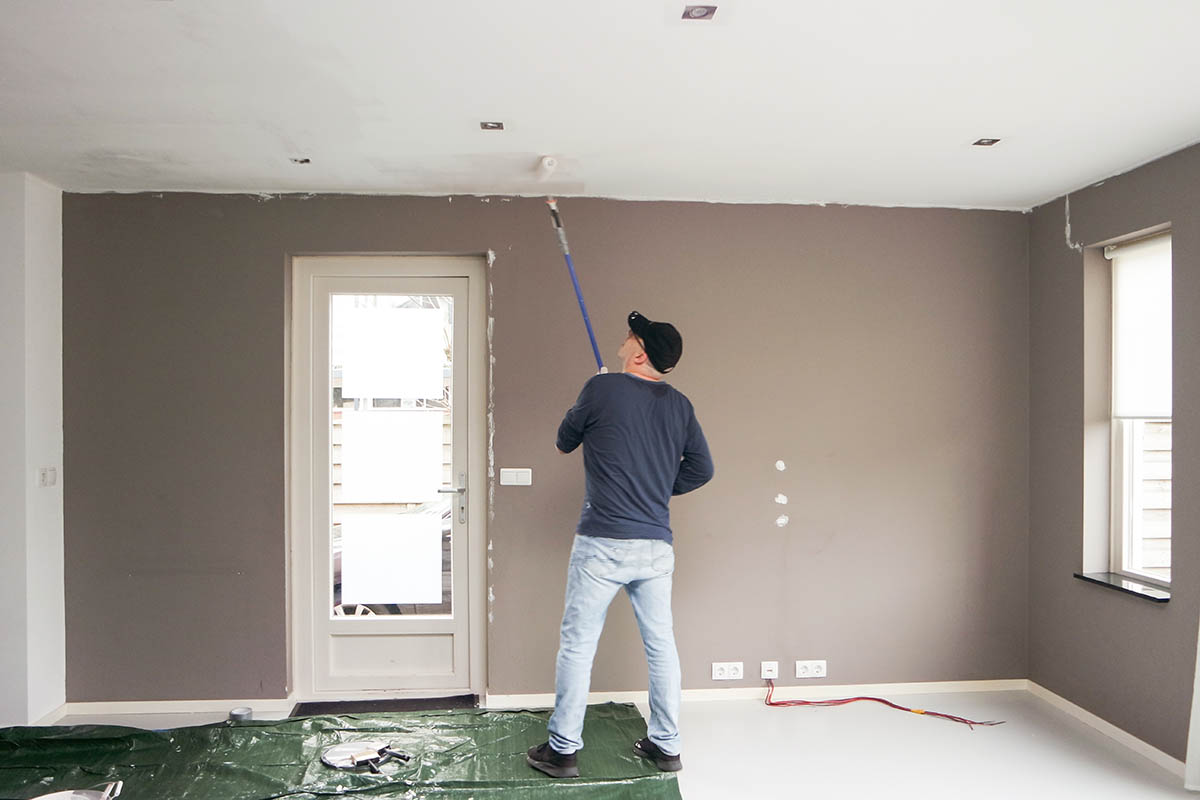 man painting a ceiling