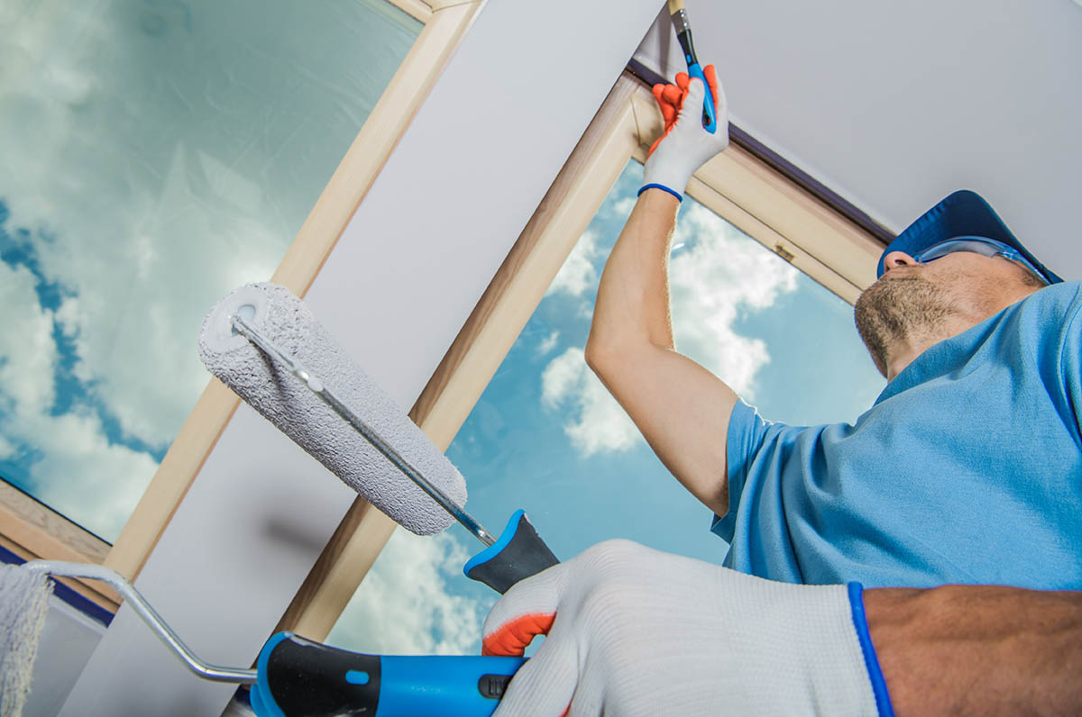 professional painter and decorator painting window
